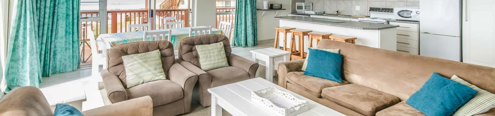 Spacious living room interior with soft sofas and cheerful color accents.